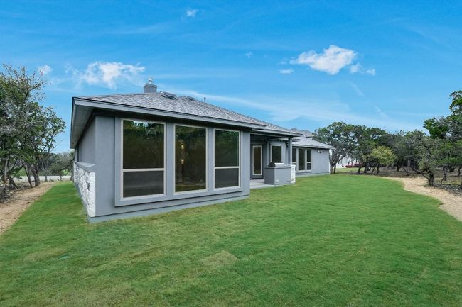 Rear view of property with stucco, and a lawn | Image 30