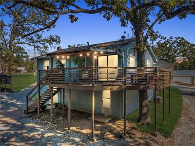 Back of property featuring a lawn and a wooden deck | Image 1