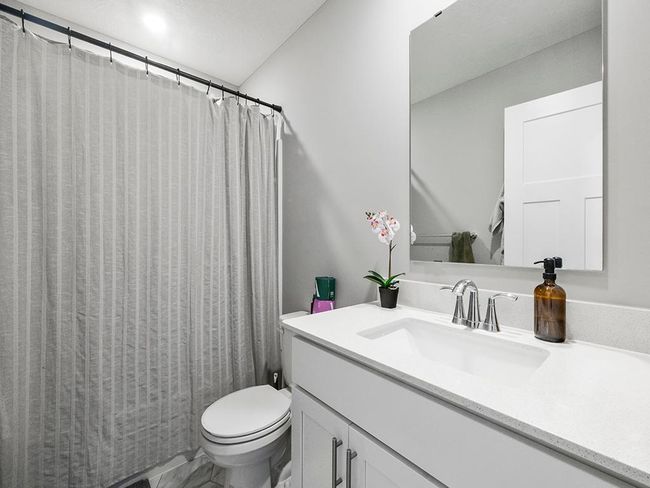 Both have easy access to a shared full bathroom, which includes a tub/shower combination and a single vanity with storage. | Image 23