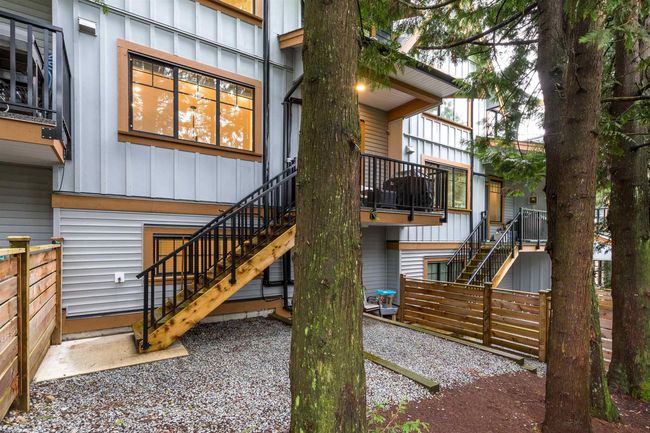 Rear view of property with fence, board and batten siding, and stairs | Image 20