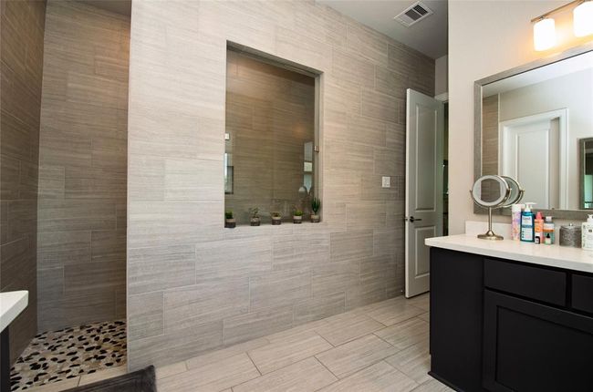 Walk-in shower and one of the two vanities. | Image 17