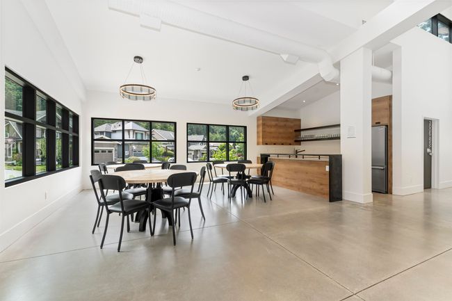 Dining room featuring baseboards, concrete flooring, and high vaulted ceiling | Image 33