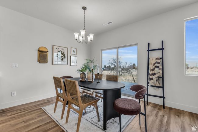 Dining room featuring a chandelier and wood-type flooring | Image 14