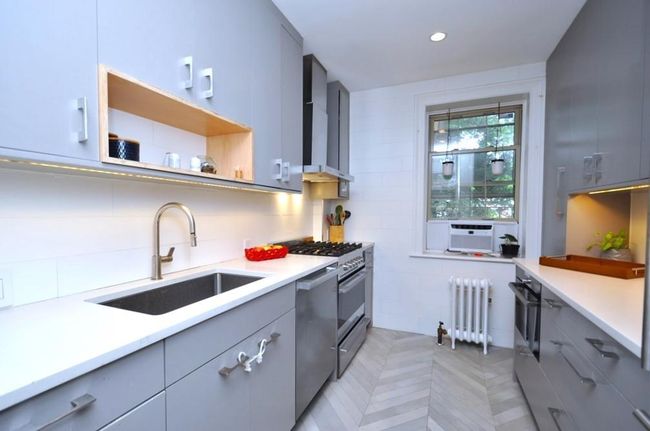 Renovated kitchen has custom cabinets, stainless steel appliances including a stove, dishwasher and steam oven. The refrigerator has matching cabinet door. Other features include a quartz counter, pantry, walk-in closet, under cabinets lighting and herringbone tile floor. | Image 7