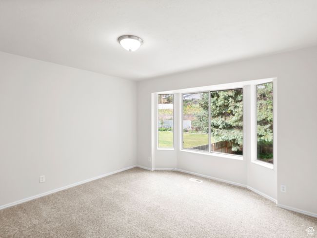 Empty room with light carpet, plenty of natural light, and baseboards | Image 13