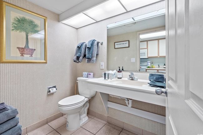 Half bathroom featuring tile patterned flooring and toilet | Image 11