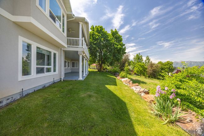 View of grassy yard featuring a patio area and a balcony | Image 38