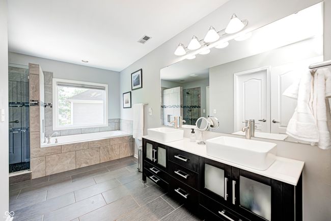 Master suite with stylish updated double vanities | Image 26