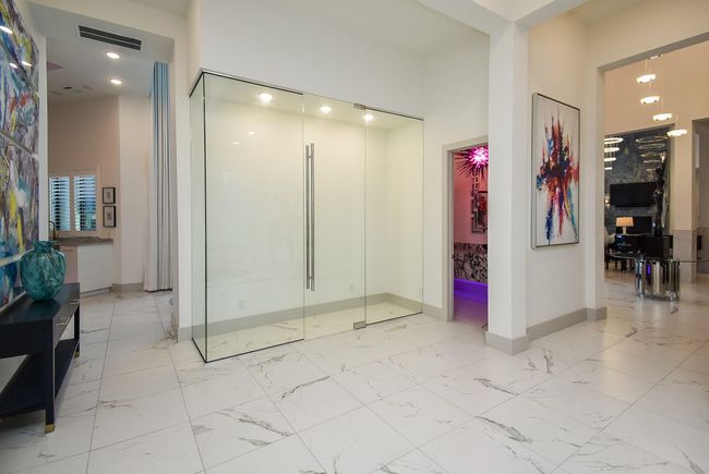 Stunning frameless glass storage area intended for wine. | Image 33