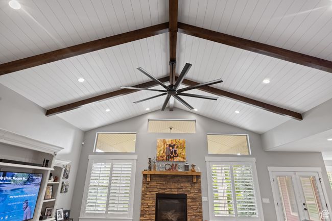 Living room with ceiling fan, a fireplace, plenty of natural light, and wooden ceiling | Image 20