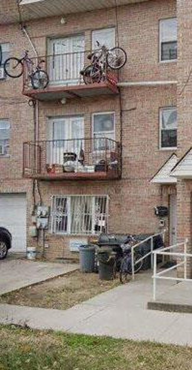 View of property featuring an attached garage and driveway | Image 7