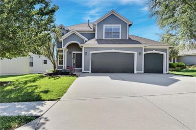 View of front of property with a garage and a front yard | Image 1