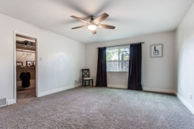 Spare room with baseboards, a ceiling fan, and carpet | Image 19