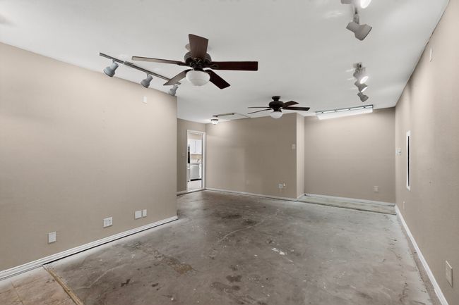 Empty room featuring concrete floors and a ceiling fan | Image 15