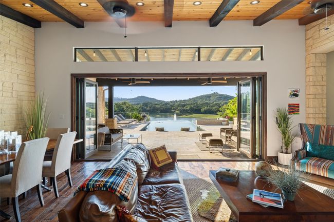 Living room featuring a ceiling fan, wood-type flooring, a wood ceiling with exposed beams, a mountain view, and recessed lighting | Image 13