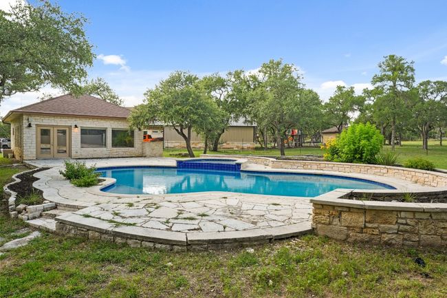 View of pool featuring french doors, a patio, and a pool with connected hot tub | Image 27