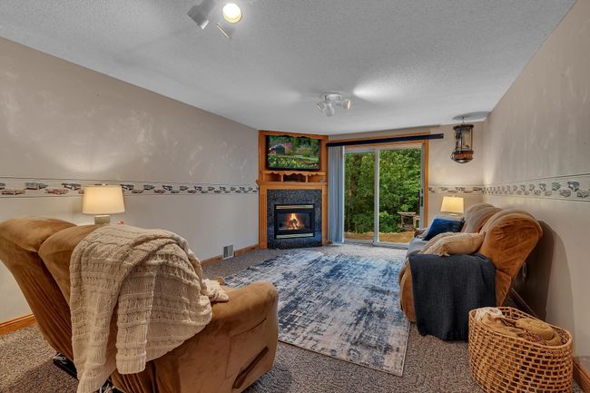 Lower level family room with walkout to the stamped concrete patio. | Image 32