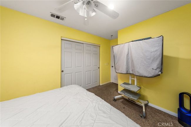 Downstairs Bedroom with Paneled Door Closet | Image 9