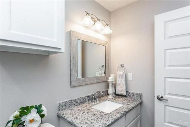 Half bathroom featuring vanity and toilet | Image 5