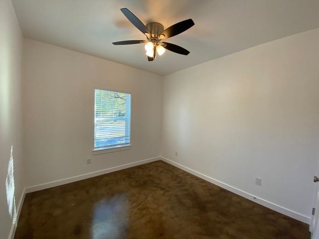 Spare room featuring baseboards, ceiling fan, and dark carpet | Image 12