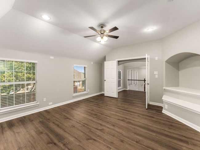 Unfurnished living room featuring dark wood finished floors, baseboards, and a ceiling fan | Image 28