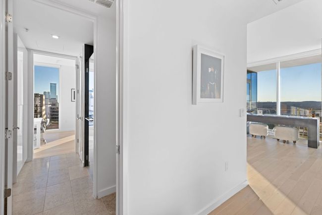 Corridor with baseboards, light wood-type flooring, and floor to ceiling windows | Image 18