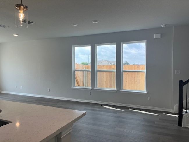 Unfurnished living room featuring dark wood-type flooring and recessed lighting | Image 4