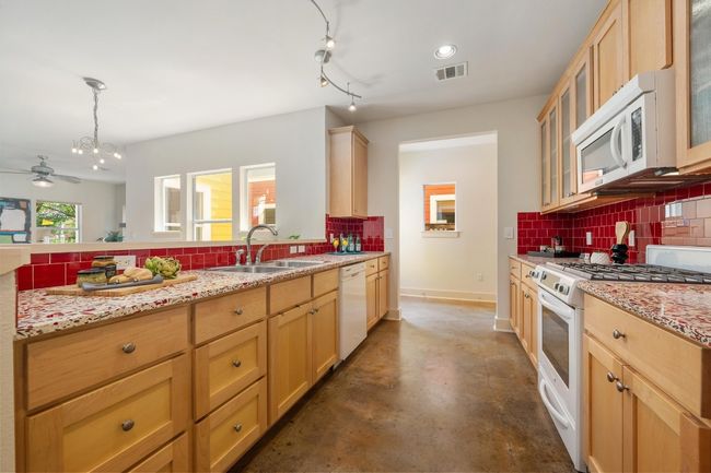 The kitchen includes ample storage with thoughtfully designed cabinetry and spacious drawers, ensuring you have plenty of room for all your essentials while keeping everything organized and within reach | Image 14