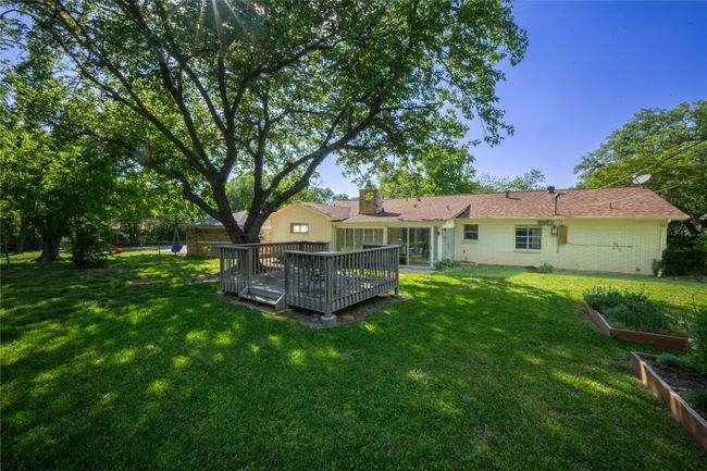 View of yard with a deck, a vegetable garden, and a fenced backyard | Image 20