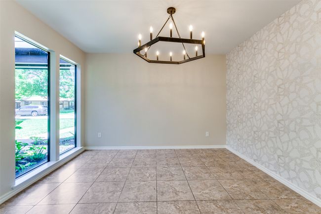 Unfurnished room featuring a chandelier and wallpapered walls | Image 26
