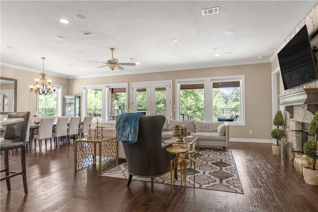 Living room featuring hardwood / wood-style flooring, ceiling fan, baseboards, crown molding, and plenty of natural light | Image 14
