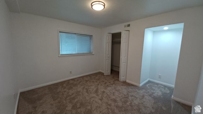 Unfurnished bedroom with carpet floors and a closet | Image 27