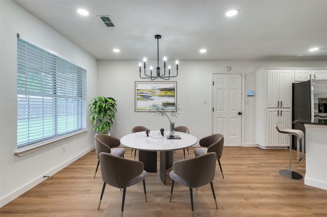 Dining area featuring visible vents, light wood-type flooring, recessed lighting, and a notable chandelier | Image 14