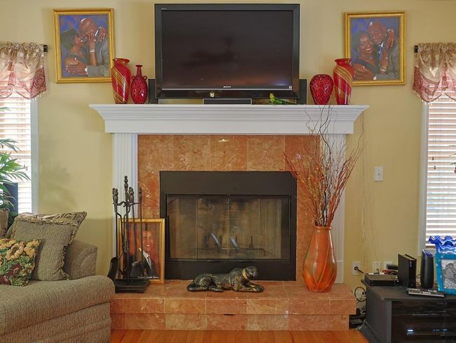Interior details with a tile fireplace and wood finished floors | Image 16