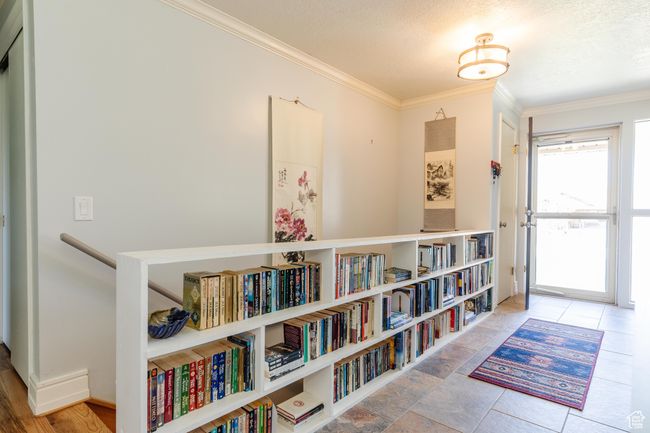 Interior space with a textured ceiling and crown molding | Image 13