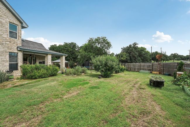 View of yard featuring a fire pit and a trampoline | Image 35