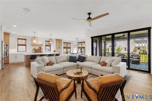 Living area featuring light wood finished floors, a ceiling fan, and recessed lighting | Image 22