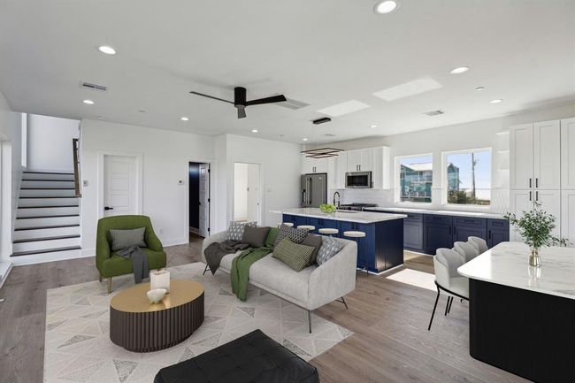 Open floor plan living seamlessly connecting the living room dining area and kitchen creating a bright and airy environment perfect for entertaining | Image 4