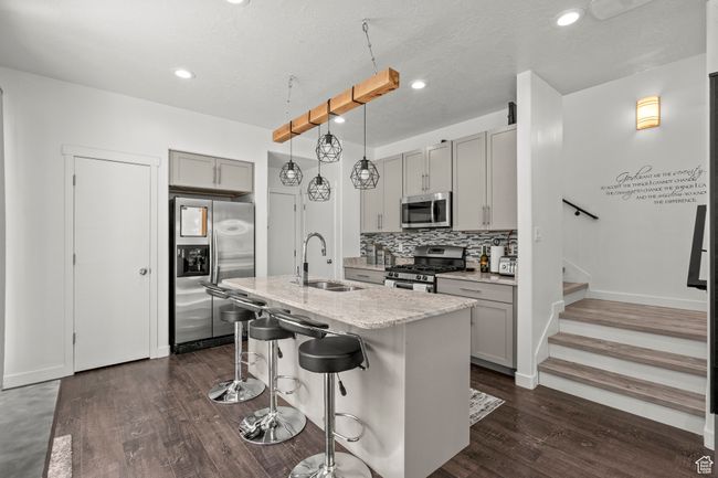 Kitchen featuring gray cabinetry, stainless steel appliances, dark wood finished floors, recessed lighting, and a textured ceiling | Image 15