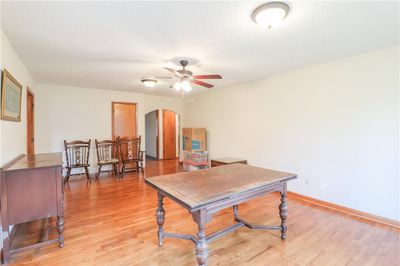 Office space with a textured ceiling, ceiling fan, and light hardwood / wood-style flooring | Image 3