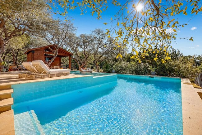 Pool with a patio area | Image 33