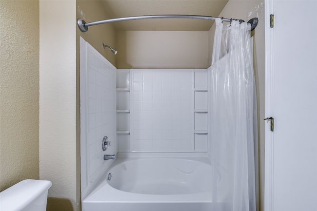 Bathroom with shower / bath combo with shower curtain and toilet | Image 14