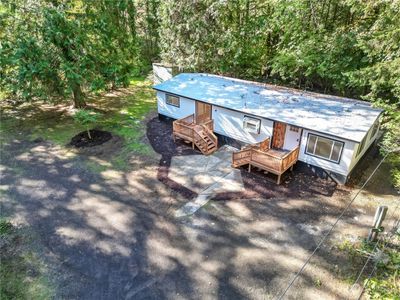 Second view of newly updated home inside and out with 3 new decks ext paint new roof electrical cedar siding and and modern updates inside. There is room to build shop garage and add other rental units around home for perfect investment | Image 2