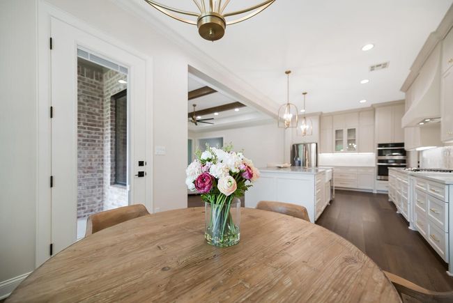 Dining room featuring dark wood-type flooring, a chandelier, beam ceiling, recessed lighting, and crown molding | Image 19