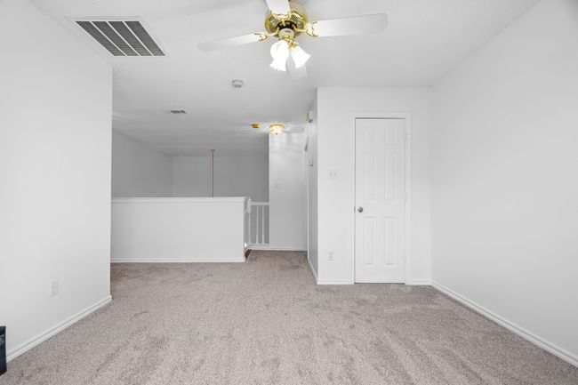 Upstairs is a open loft area with a balcony. | Image 22