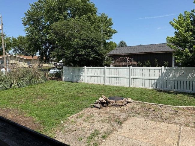 View of yard with an outdoor fire pit | Image 16