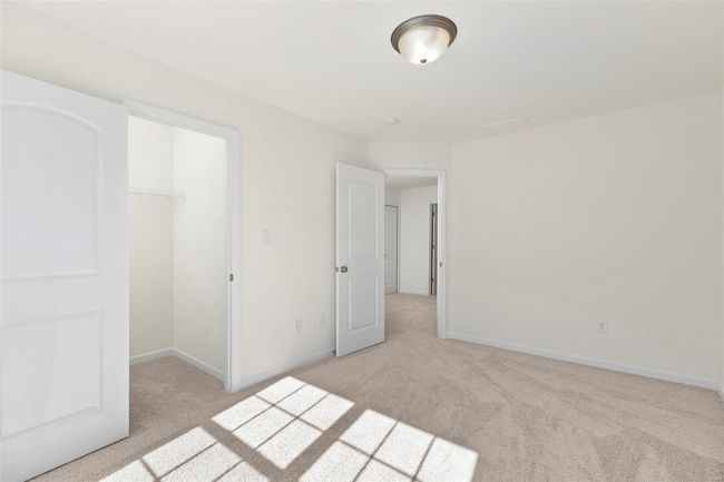 Unfurnished bedroom with a closet and light colored carpet | Image 4