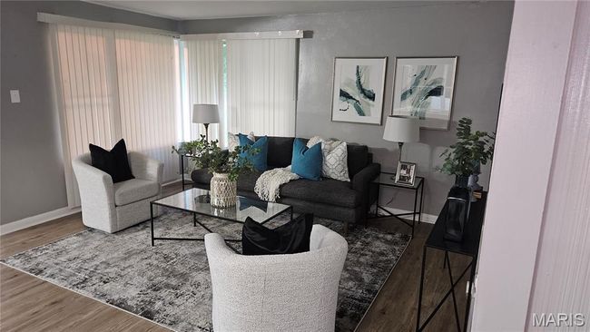 Living area featuring baseboards and wood finished floors | Image 6