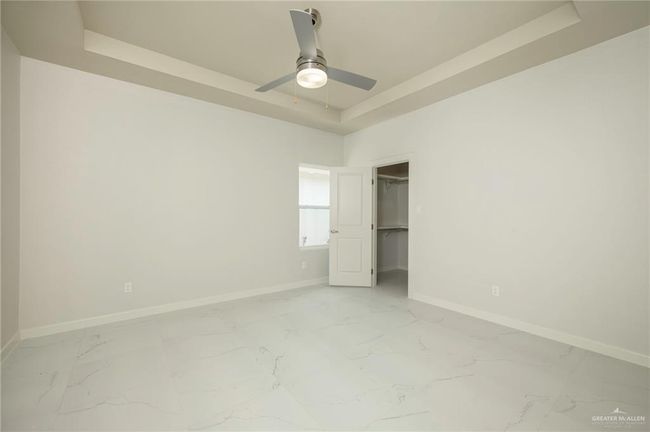 Unfurnished bedroom with light marble finish floors, baseboards, and a tray ceiling | Image 15