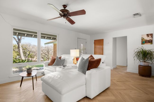 Living room featuring a ceiling fan, visible vents, and baseboards | Image 15